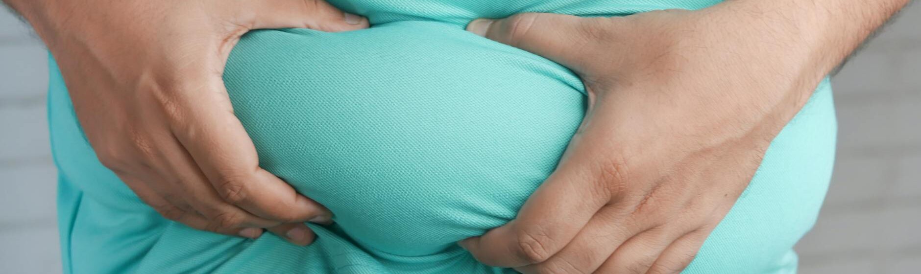 a person holding his belly fat